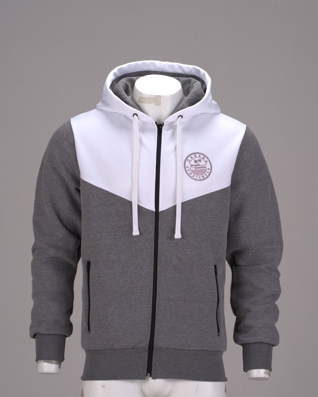Raw studio capture of the same Canada Sportswear zip hoodie on a visible mannequin form before invisible-mannequin retouching